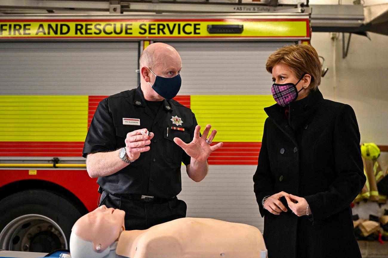 Scottish Fire and Rescue Service Group Commander Paul Blackwood shows First Minister of Scotland Nicola Sturgeon how to administrate naloxone at Bathgate Fire Station in Bathgate, Scotland, Britain, February 9, 2022.